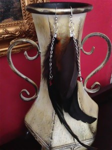 Brown feathers with burnt orange embellished with red Swarovski crystals on silver chains